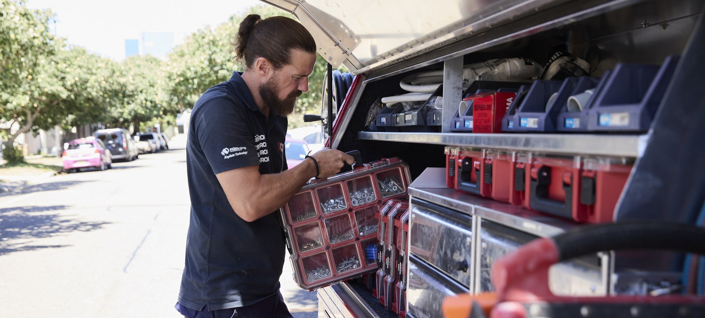 Electrician getting tools out of a truck